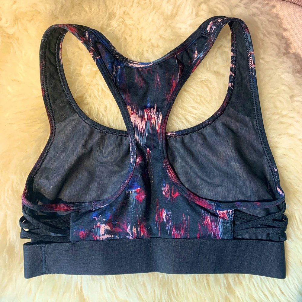 Victoria’s Secret sports bra with peep cross side-body design, size XS.